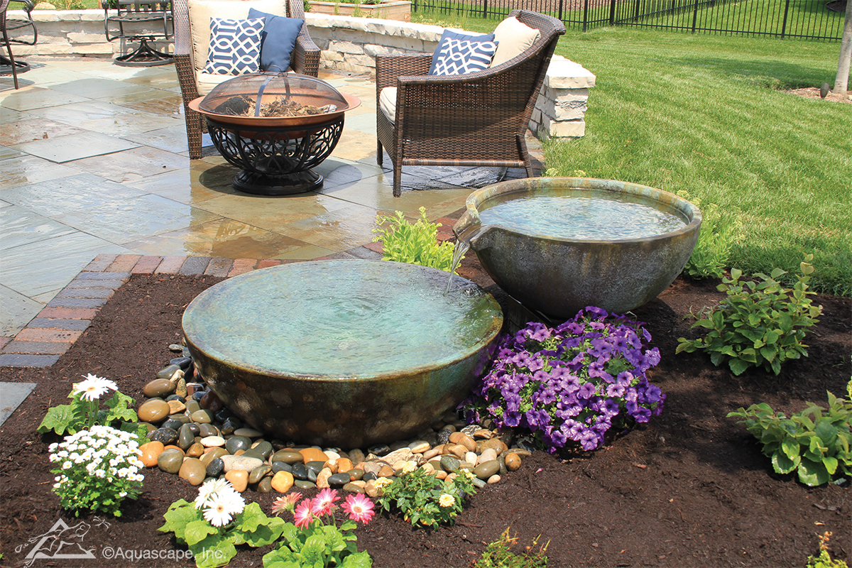 Aquascape spillway bowl water feature in landscaped garden